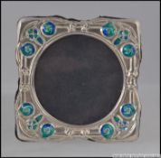 A silver and enamel set easel picture frame H8cm
