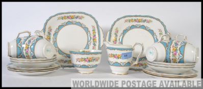 A 20th century vintage Bone China Staffordshire tea service in a chintzy pattern,