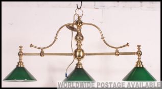 A modern brass ceiling mounted, hanging, snooker table down light.