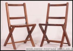 A stunning pair of vintage oak childrens folding chapel chairs.