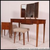 An original Gordon Russell walnut dressing table of five drawers with triple mirror having fabulous