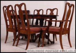 A large Regency style mahogany dining table together with a set of matching mahogany dining chairs