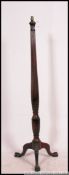 A 19th century Regency mahogany standard lamp on splayed leg tripod base with carved and tapered