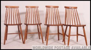 A set of 4 1970's Ercol style stick back beech wood dining chairs.