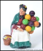 A Royal Doulton figurine HN1315 The Old Balloon Seller being stamped to the base with the old green