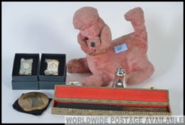 A mixed lot to include a vintage stuffed toy dog with inbuilt radio to underside, two clocks,