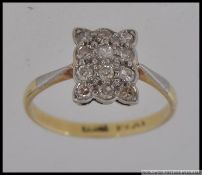 An 18ct gold, platinum and diamond ring having approx 25pnts of diamonds to the square mount.