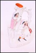 A Victorian Staffordshire flatback figurine / diorama entitled ' The Rival ' being raised on