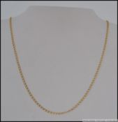 A 9ct gold curb chain link necklace with spring hoop clasp. Measures 20 inches. Weight 4.8g.