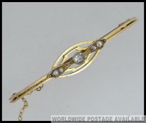 A 9ct gold seed pearl and clear stone set ladies bar brooch with pin and chain.