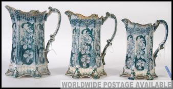 3 Victorian staffordshire graduating jugs in blue/turquoise and white with scrolled handles to each.