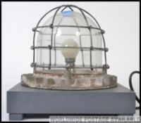 A vintage industrial bulkhead light, converted into a table lamp.
