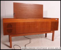 A retro 1970's teak stereogram sideboard with vented panel front, hinged top with inset record deck.