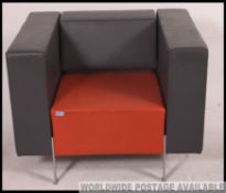 A great vintage retro orange and grey vinyl armchair on powder coated metal legs,
