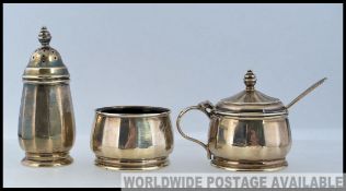 A hallmarked silver condiment set, with hallmarks to the base.