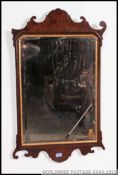 A 19th century large pier mirror. the central mirror plate with mahogany scrolled frame.