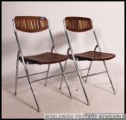 A good pair matching of vintage mid century folding tubular chrome and teak kitchen / garden chairs,
