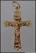 A 9ct gold crucifix pendant marked 375. Measures 3.5cm. Weight 1.3g.