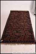 A Persian handwoven rug blue ground with geometric borders and hare / rebbit design