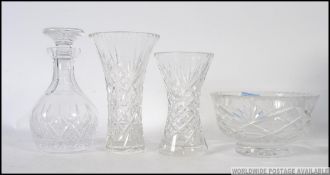 A cut glass Edinburgh Crystal decanter along with a Stuart decanter and matching glasses.