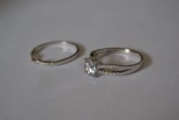 A designer 925 silver stacking ring set with a central clear stone with split shoulders with