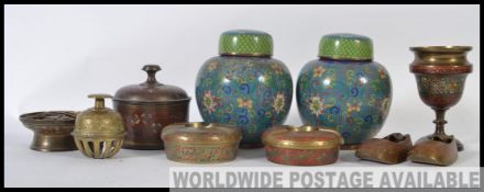 A pair of Chinese enamel worked ginger jars along with a collection if Indian brasswares to include