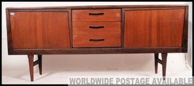 A good retro 20th century Danish influence teak sideboard raised on angular supports with a central