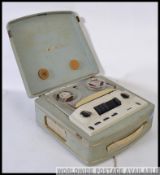 A vintage 1950's tape to tape reel player in the original vinyl light blue case