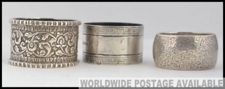 A collection of 3 silver napkin rings, one Victorian with hallmarks for Birmingham 1889.