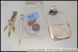 A sterling silver propelling pencil together with a white metal hip flask,
