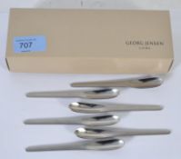 A set of boxed Georg Jenson made , Arne Jacobsen designed espresso spoons, appear to be unused.