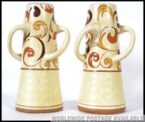 A pair of Art Deco shaped Bewley pottery flower vases.