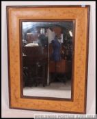 A large decorative 20th century mirror having stencil painted borders to the pine frame with