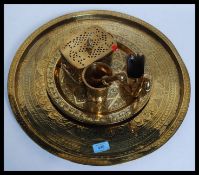 A collection of brass wares to include a large circular wall charger, an incense box,