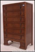 A 1930's Art Deco century chest of drawers having central bank of 6 drawers all over kick feet