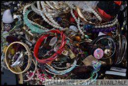 A collection of unsorted costume jewellery to include bracelets, bangles,