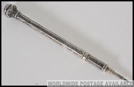 A silver hallmarked propelling pencil , having chase decoration,