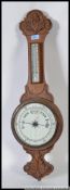 A 1920's aneroid banjo barometer having milk glass facia and thermometer above H80cm