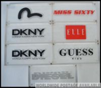 A collection of seven fashion house point of sales adverting blocks, being constructed from perspex,