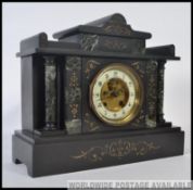 A late Victorian black marble mantel clock of Palladium design having Corinthian column decoration