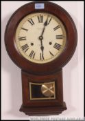 A contemporary Victoria President 31 day mahogany cased wall clock set in shaped case with glass