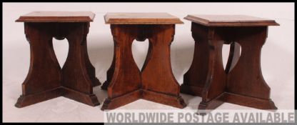 A set of 3 19th century Arts & Crafts eclesiastical side tables raised on x-frame pierced bases
