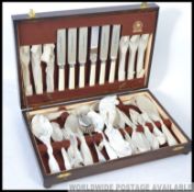 A vintage mid century wooden cased canteen of cutlery by Debesco.