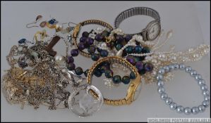 A collection of white and yellow metal and other costume jewellery to include watches, earrings,