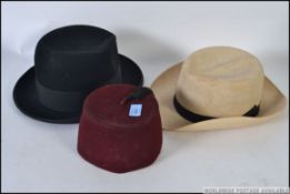 A vintage 20th century Fez together with a gentlemans bowler / fedora hat