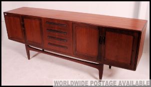A good retro 1970's long and low G plan Fresco teak sideboard enclosed by moulded panelled door
