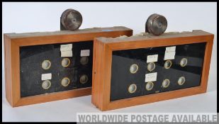 A pair of early 20th century vintage industrial servant / maid 12 window bell box room indicators