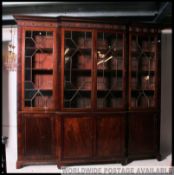 A 19th century Georgian mahogany breakfront library bookcase cabinet.