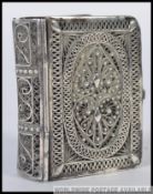 A 19th century silver filigree worked continental miniature book of poems.