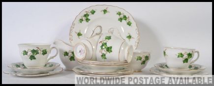A Colclough part tea service in the Ivy pattern consisting of cups, saucers, side plates,